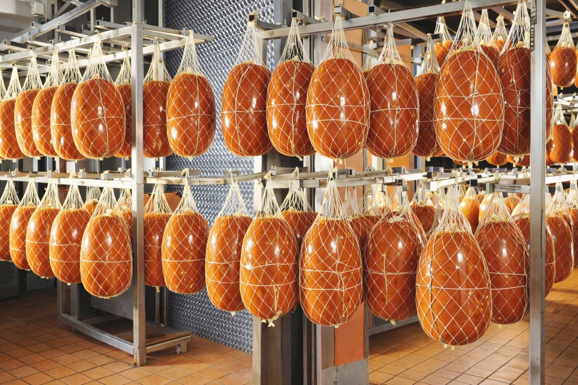 Authentic mortadella production process in Bologna captured during a Bologna Italy Food Tours culinary tour.